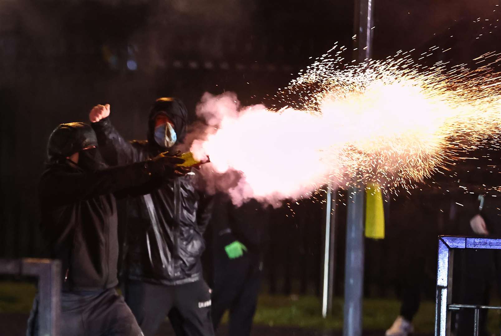 Youths fire fireworks at the PSNI on the Springfield road, during further unrest in Belfast in April 2021 (Liam McBurney/PA)