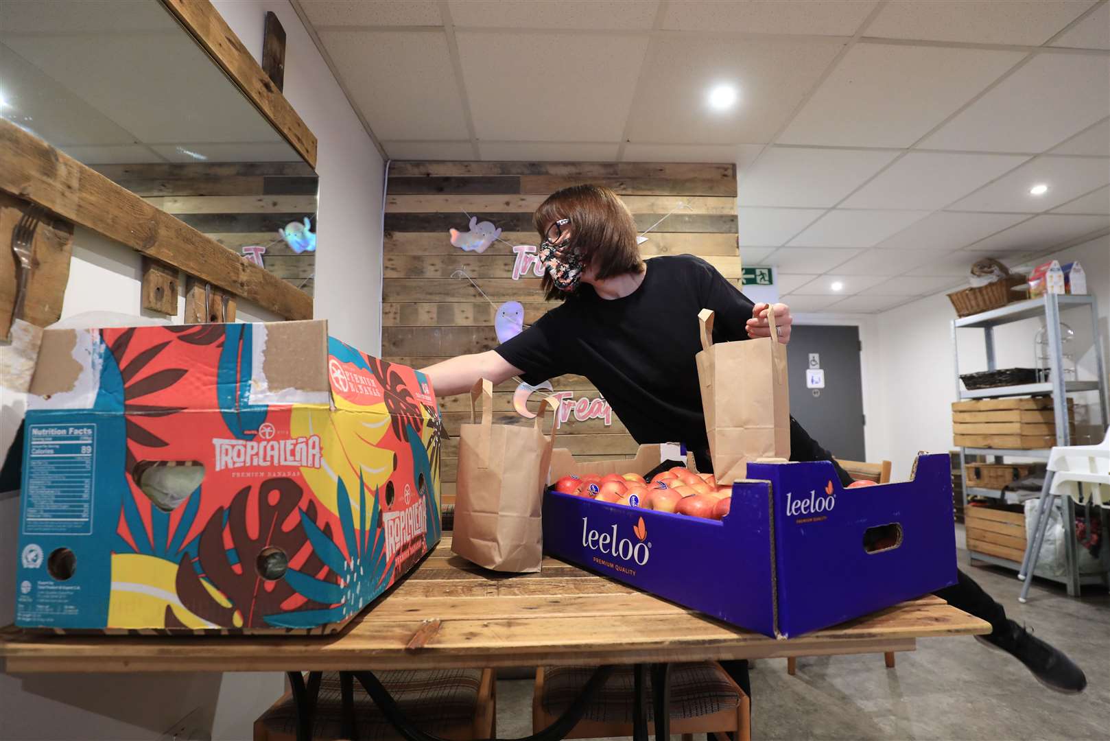 Dawn Grain, manager of the Rumour Cafe in Sheerness, Kent, prepares bags of food (Gareth Fuller/PA)