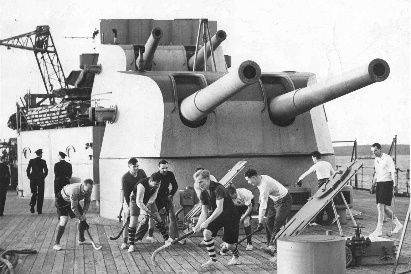 Officers of HMS Kent enjoying a game of deck hockey