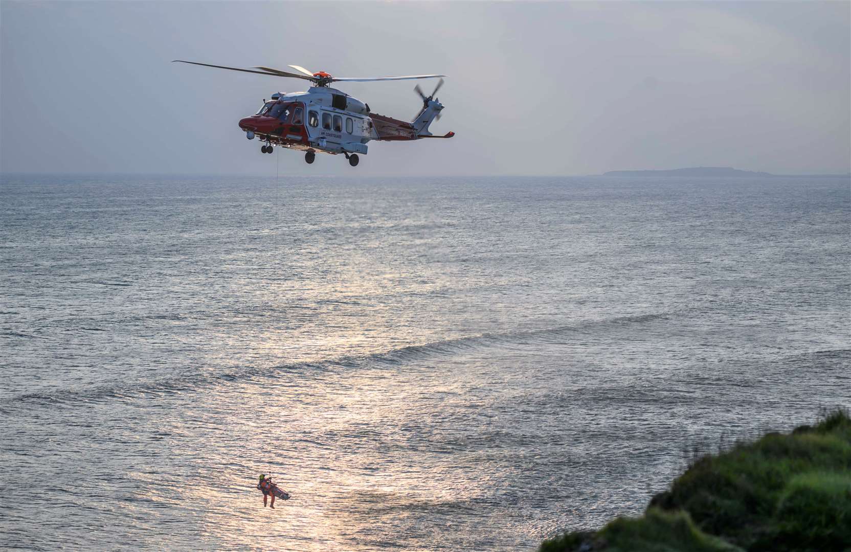 The coastguard helicopter is involved in the rescue. Picture: Jason Ludlow