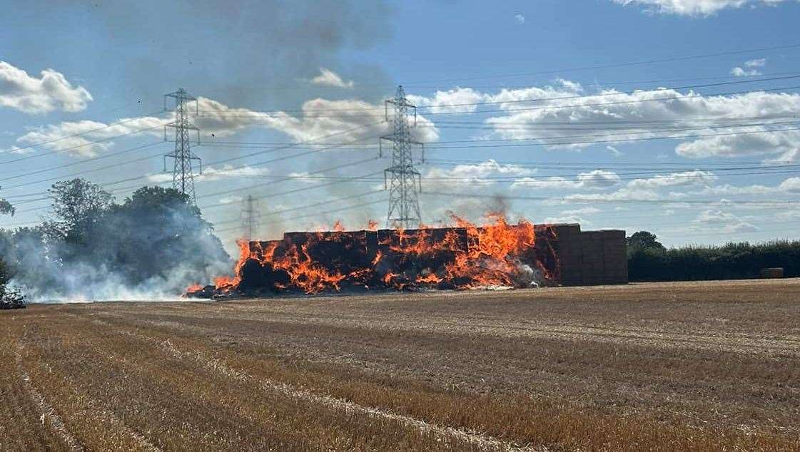 A stack of hay bales are on fire in Ifield