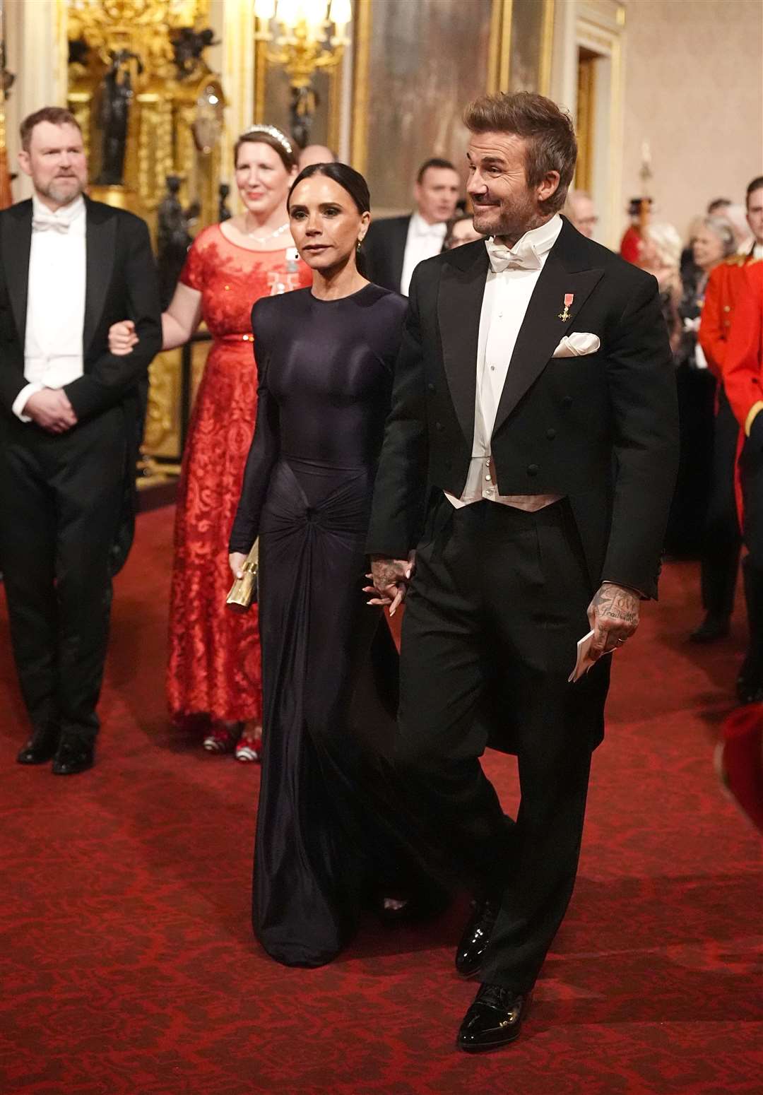 David and Victoria Beckham make their way along the East Gallery to attend the Qatari state banquet (Aaron Chown/PA)