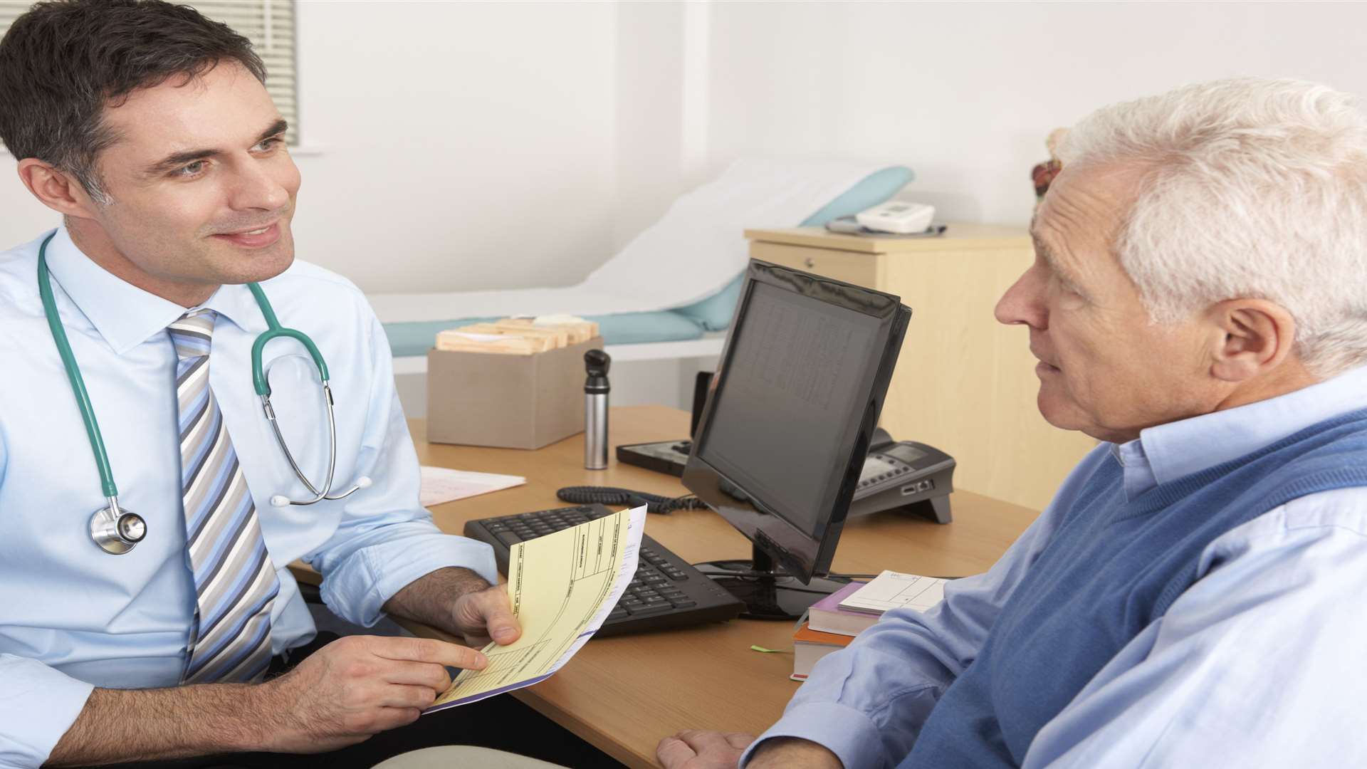 Stock picture of GP in a surgery with patient