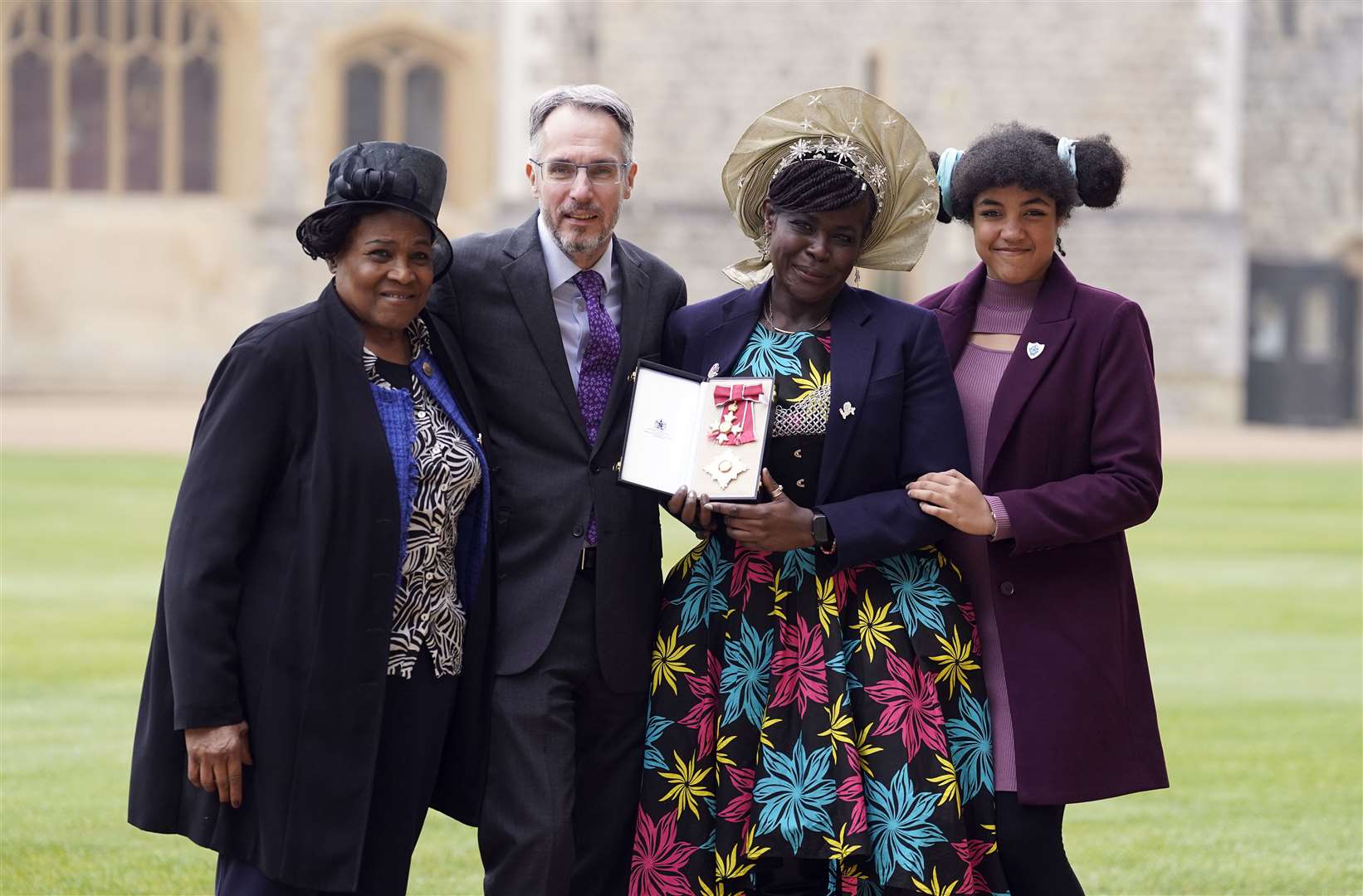 Dame Margaret Aderin-Pocock, second right, with her daughter Lori (right), husband Dr Martin Pocock (second left) and mother Carol Phillips (left) at Windsor Castle (Andrew Matthews/PA)