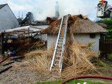 Fire crews tackle a massive blaze in a thatched roof at Wooton, near Canterbury. Picture: KFRS