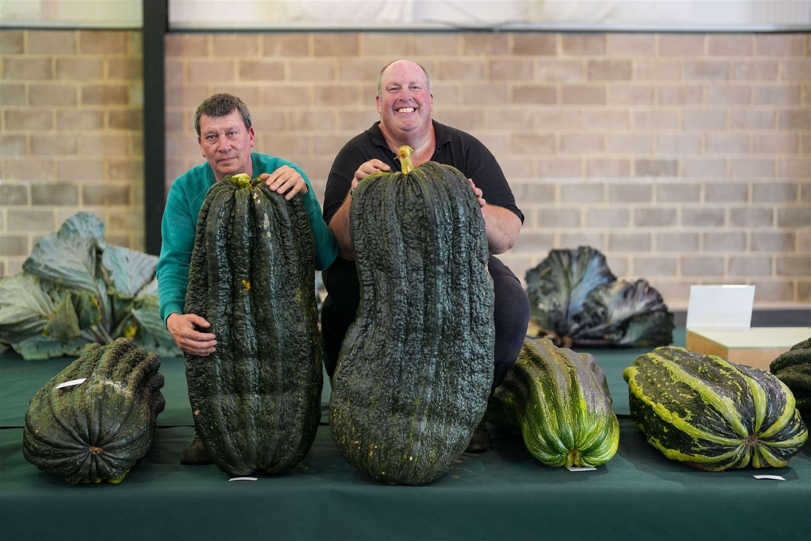 Carl Lambourne and Tim Saint with marrows they have entered ahead of the UK national giant vegetables championship (Jacob King/PA)