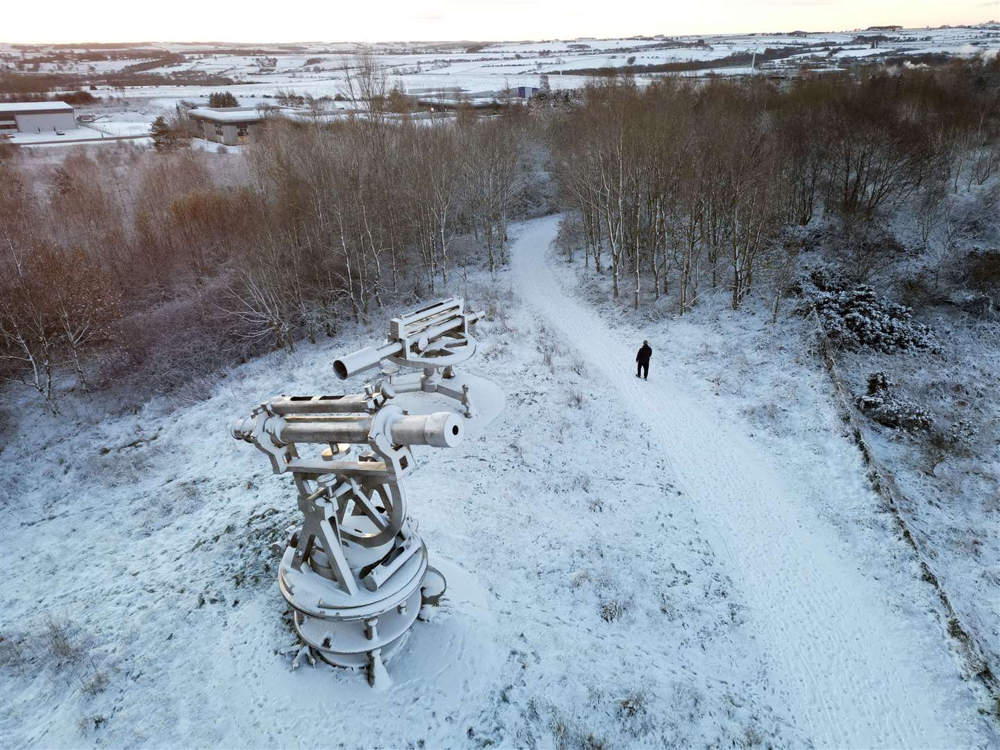 A man walks through overnight snow near the Terris Novalis sculpture in Consett (Owen Humphreys/PA)