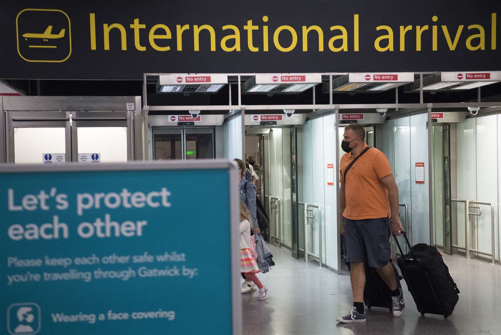 Passengers arrive at Gatwick airport (Kirsty O’Connor/PA)