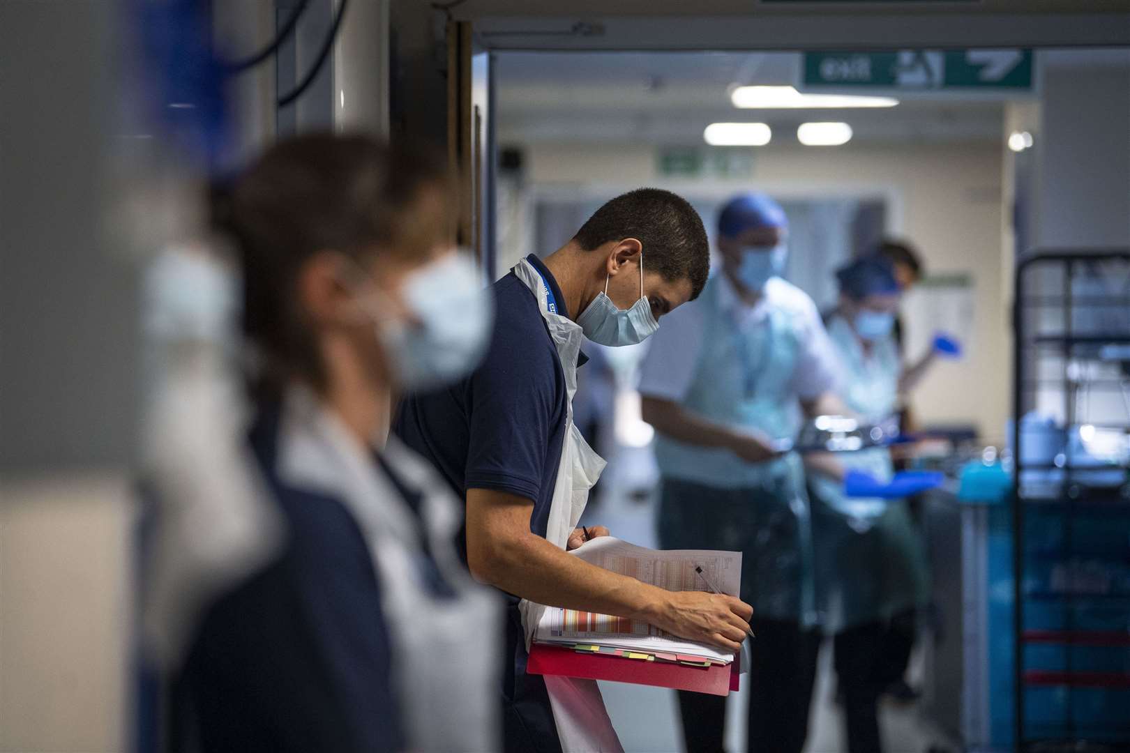 A Rehab Support worker checks on patient notes as the first patients are admitted to the NHS Seacole Centre at Headley Court (Victoria Jones/PA)