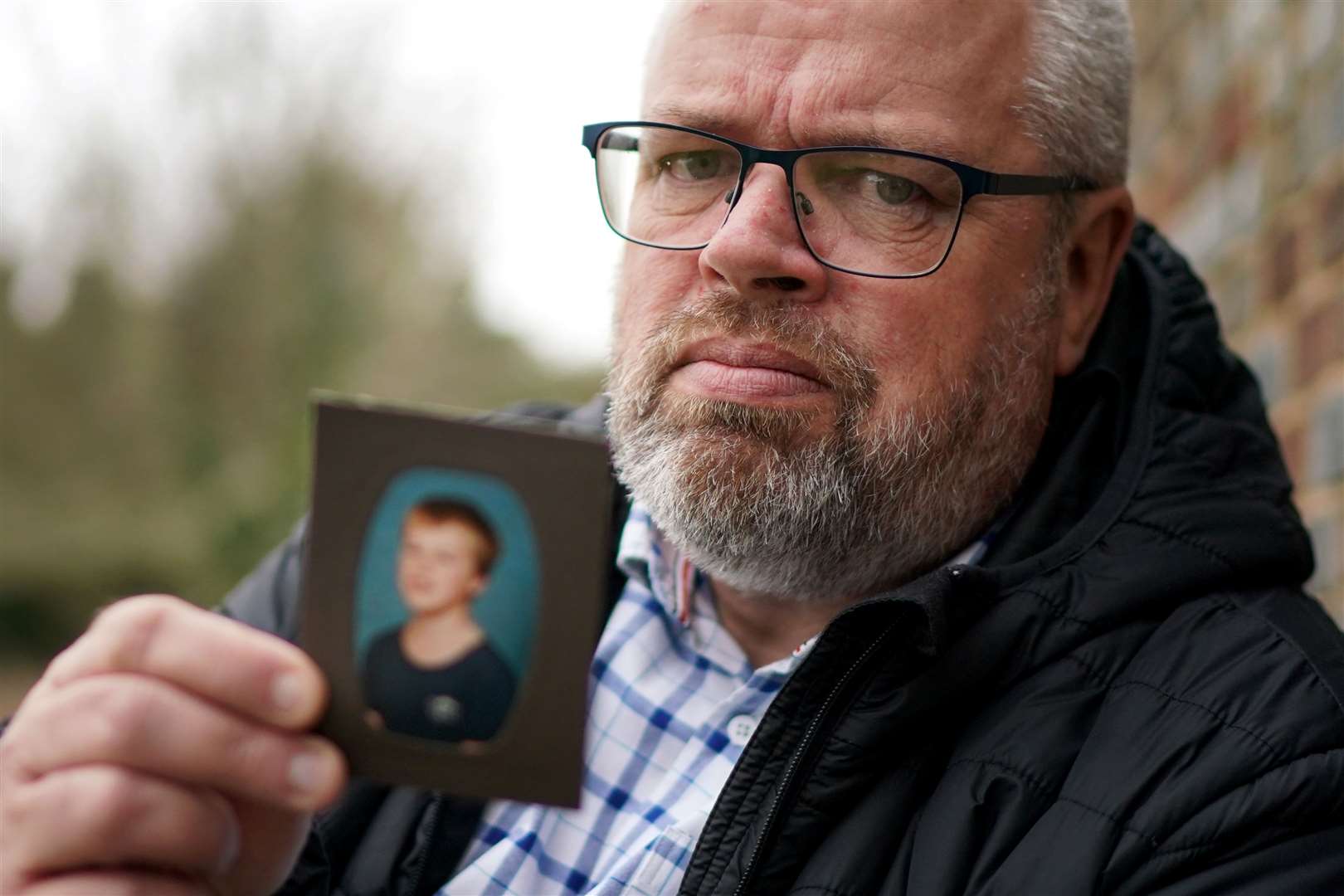 Stephen Lewsey holds a picture of himself as a young boy (Gareth Fuller/PA)