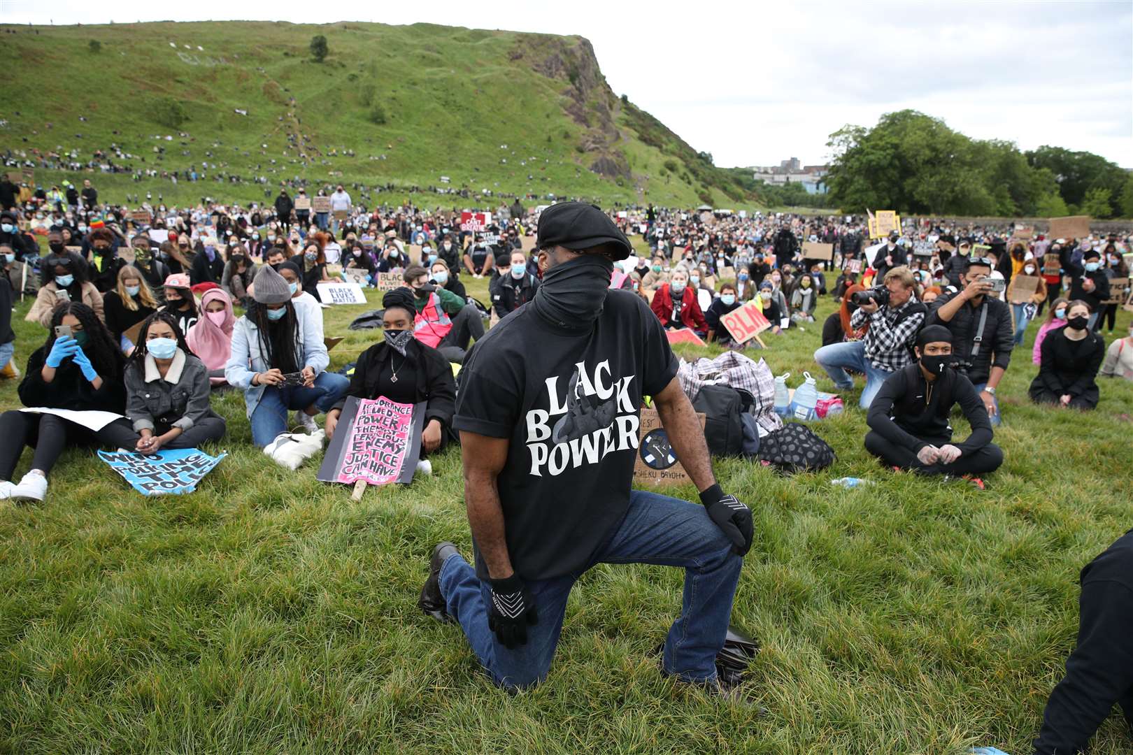 People kneel during a Black Lives Matter protest rally in Edinburgh (Andrew Milligan/PA)