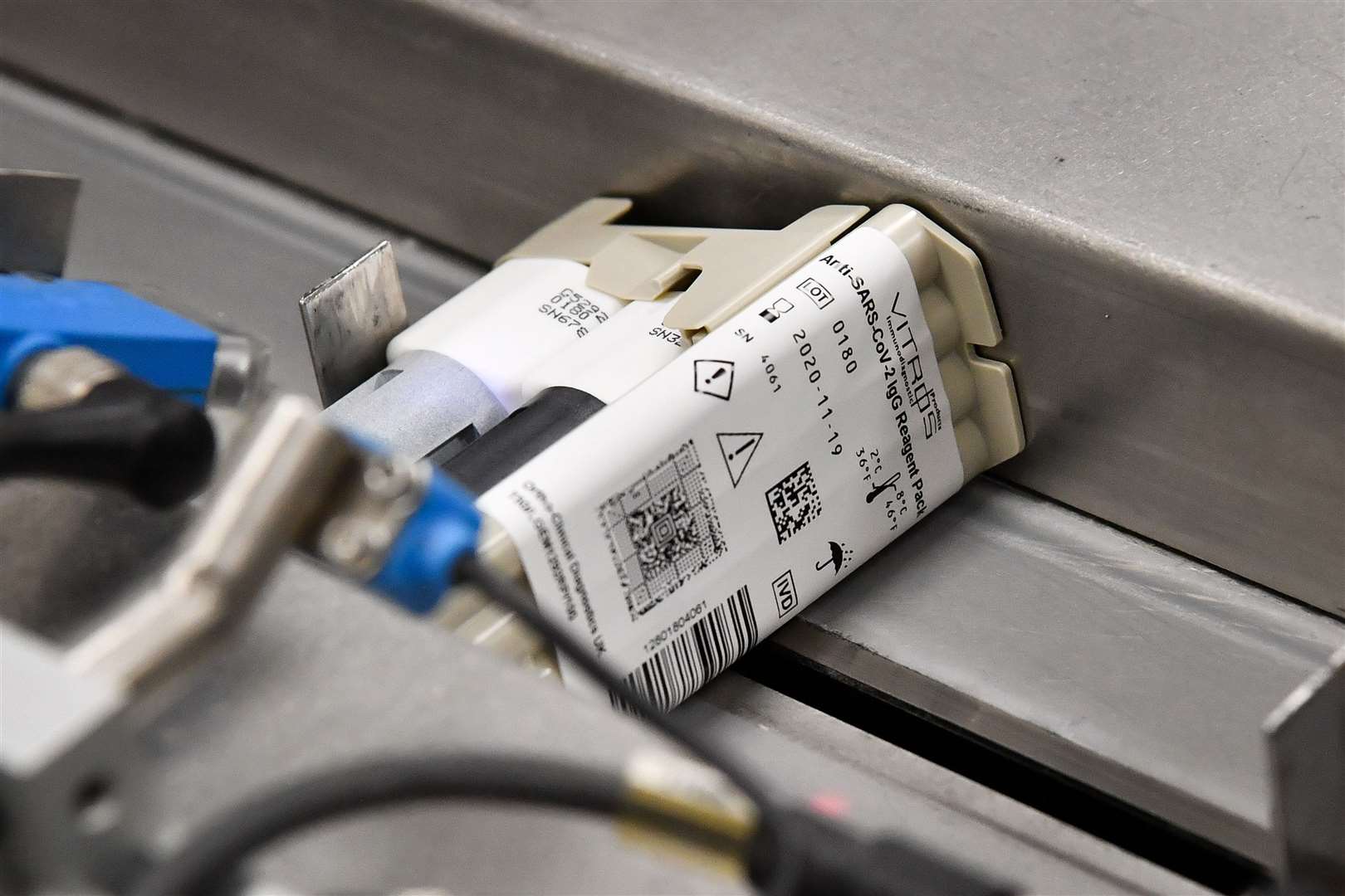 A Covid-19 antibody testing kit moves along the factory line (Ben Birchall/PA)