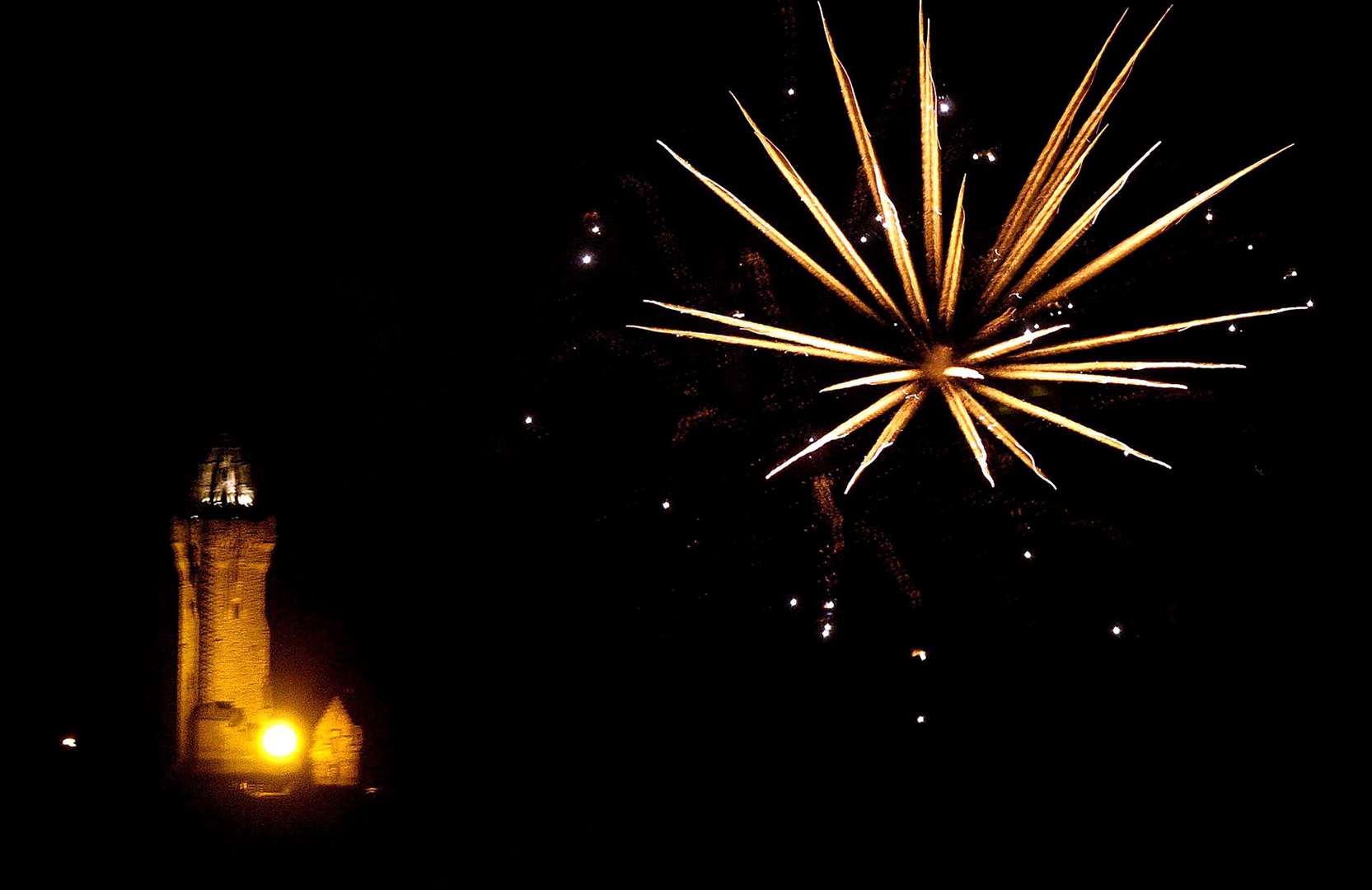 Fireworks explode over the Wallace Monument during a Guy Fawkes Night display at Bridge of Allan, Stirling (Andrew Milligan/PA)