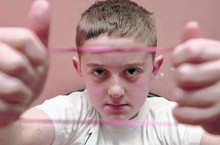 Callum Beckett, 11 has picked up 130 rubber bands and is concerned about the amount of money being wasted. Picture: Matthew Reading