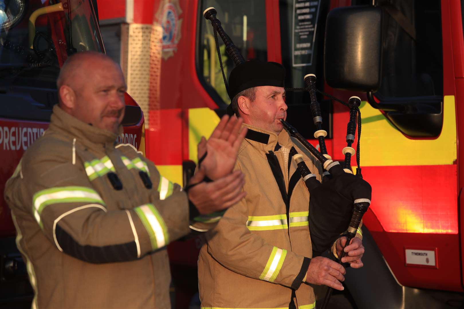 Firefighter Andy Burns played the bagpipes at Tynemouth Community Fire Station (Owen Humphreys/PA)