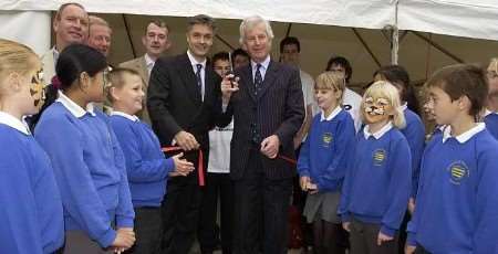 Cllr Kevin Lynes, centre left, and Sir Sandy Bruce-Lockhart, cut the ribbon, watched by pupils from All Saints' School. Picture: ANDY PAYTON