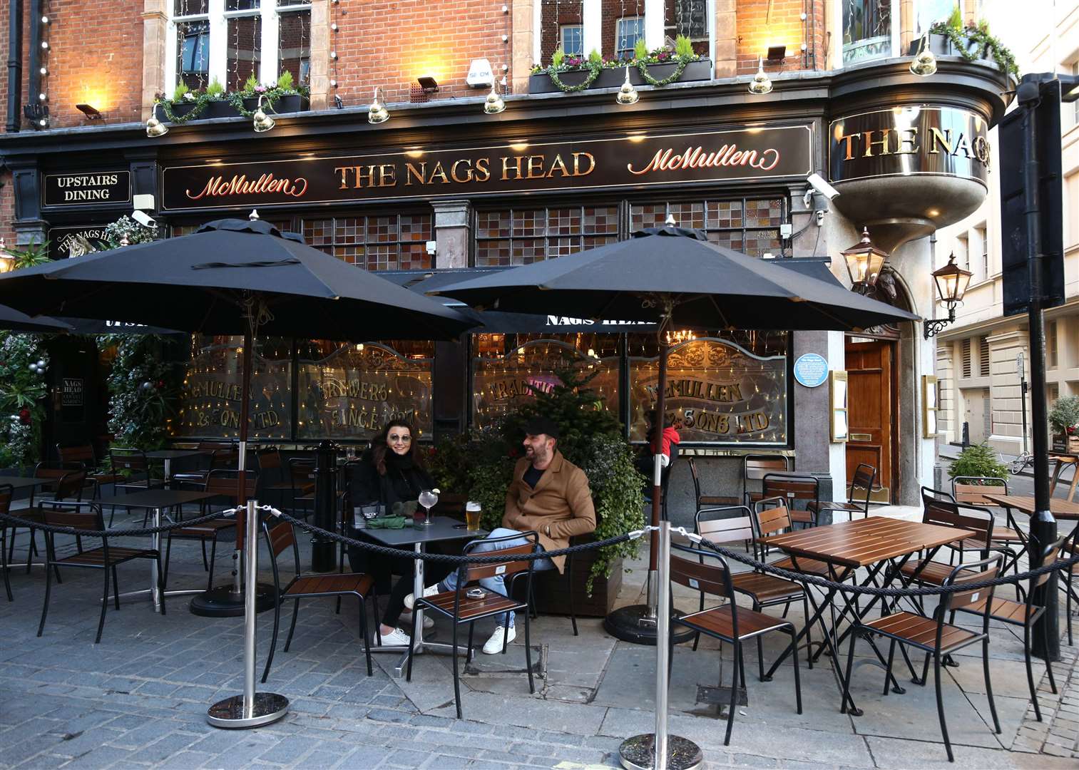 People drinking on an outdoor table at The Nags Head pub in Covent Garden, London (Yui Mok/PA)