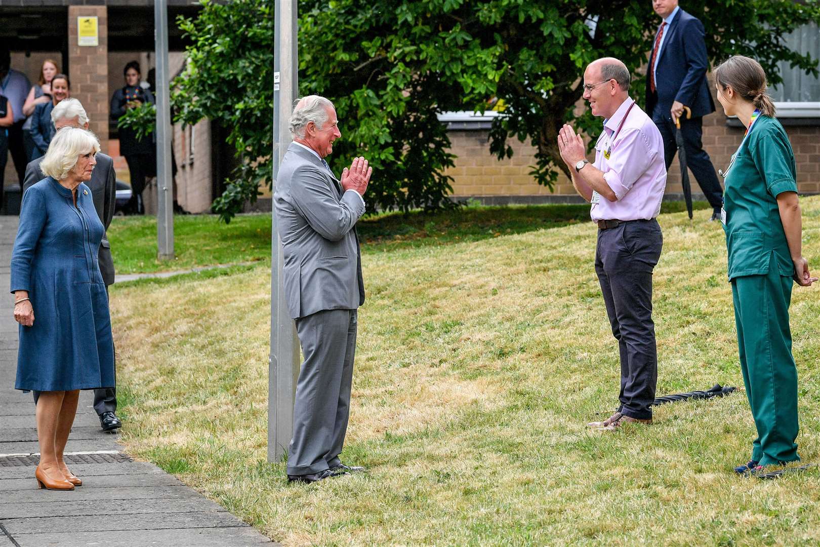 The Prince of Wales remains socially distanced as he a performs a namaste to Professor Mark Pietroni (Ben Birchall/PA)