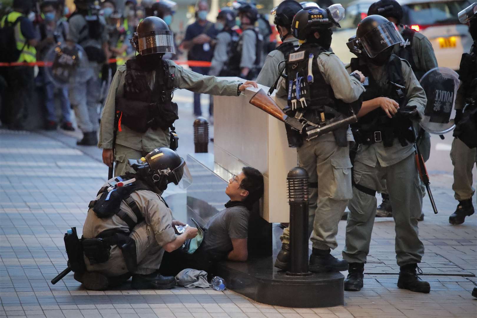 Police detaining a protester in Hong Kong (AP)