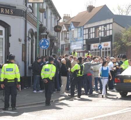 Police keep an eye on supporters outside one of the town's pubs. Picture: Barry Crayford