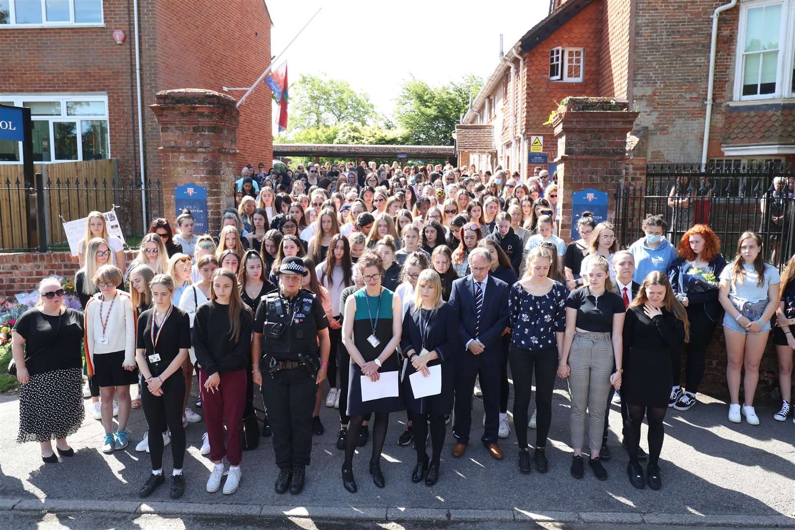 Colleagues and pupils of teacher James Furlong take part in a period of silence at the Holt School (Steve Parsons/PA)