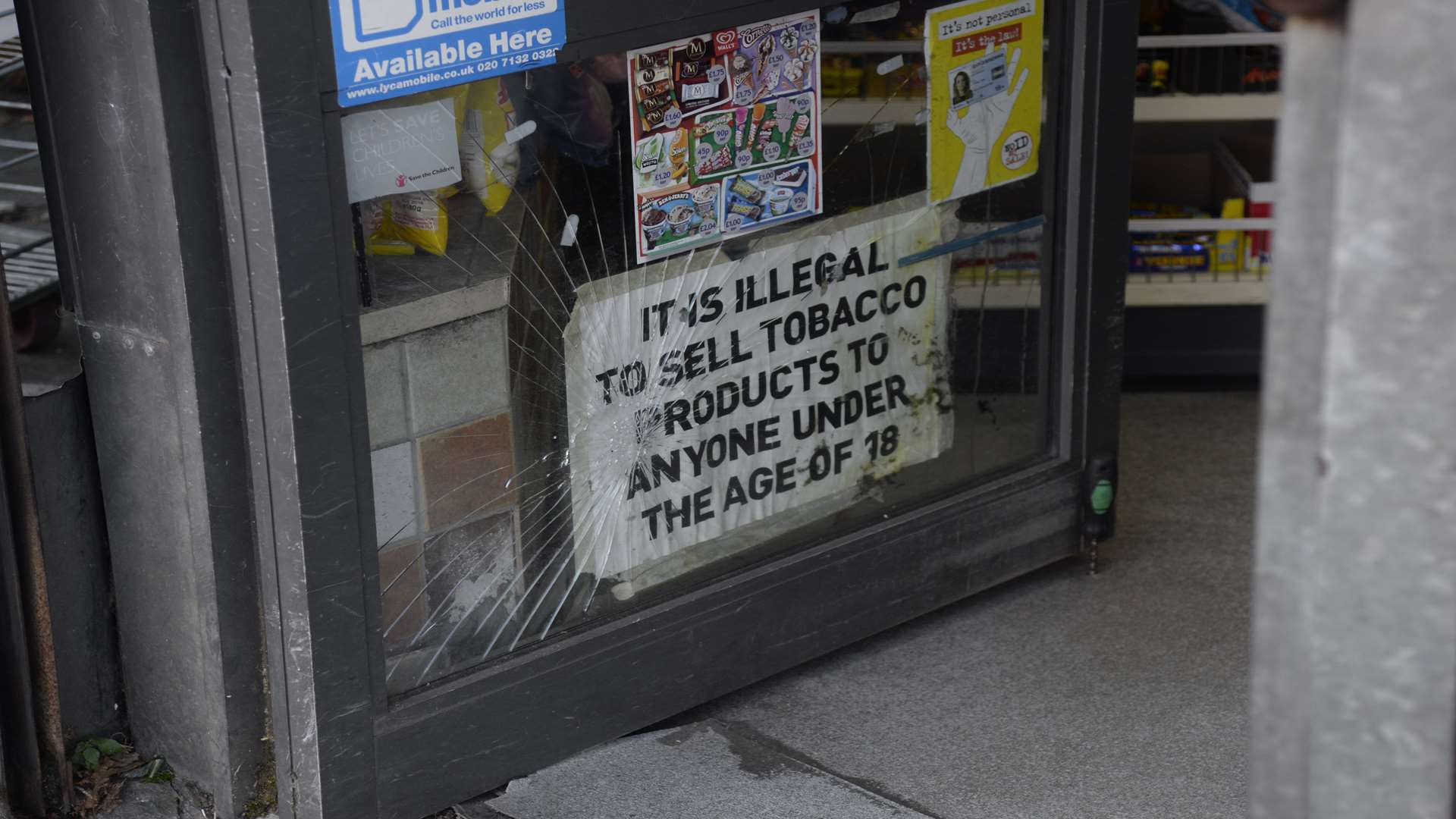 The lower window pane of the Mace corner shop was smashed. Picture: Chris Davey