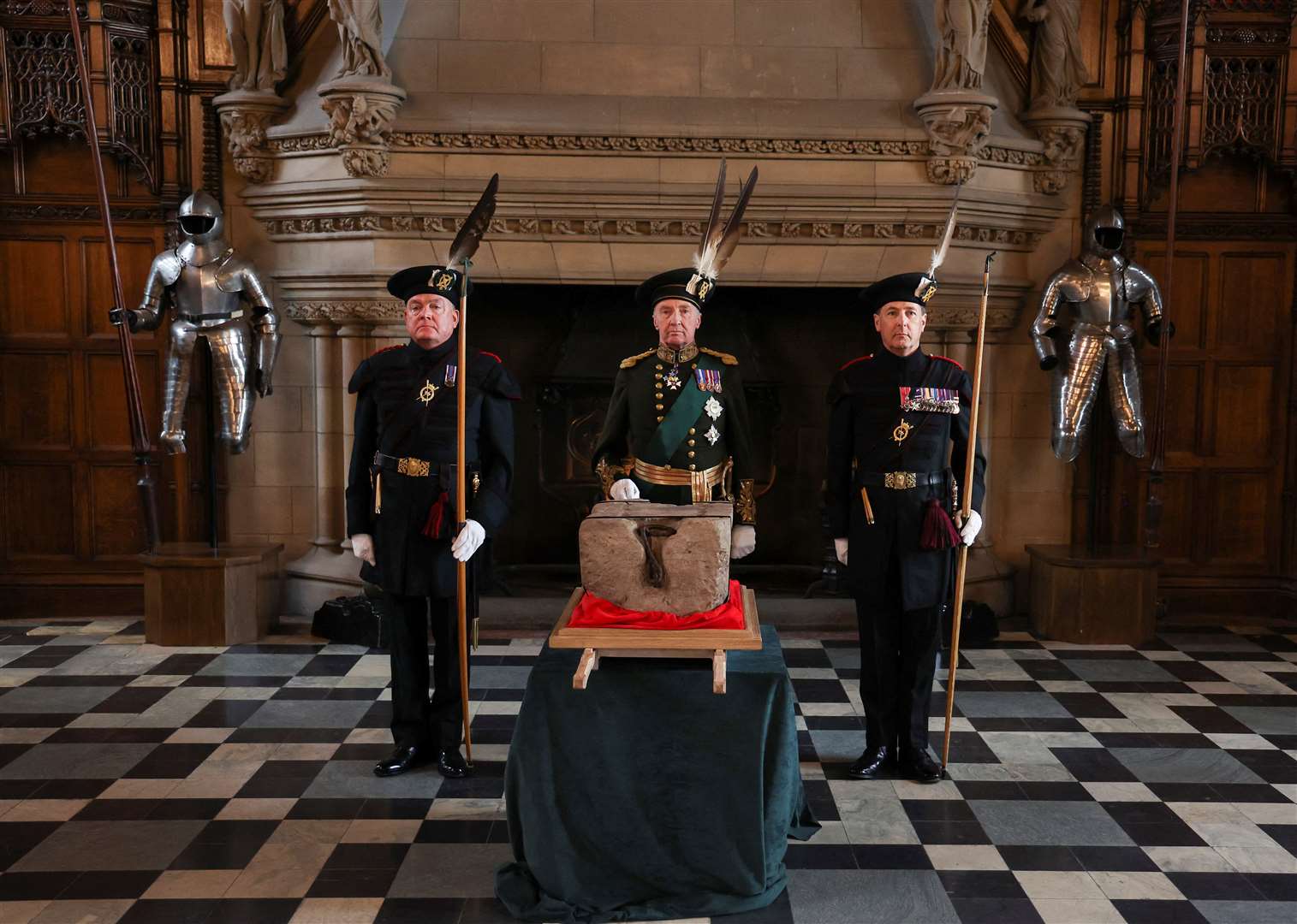 The Duke of Buccleuch, flanked by two Officers of Arms, stands beside the Stone of Destiny (Russell Cheyne/PA)