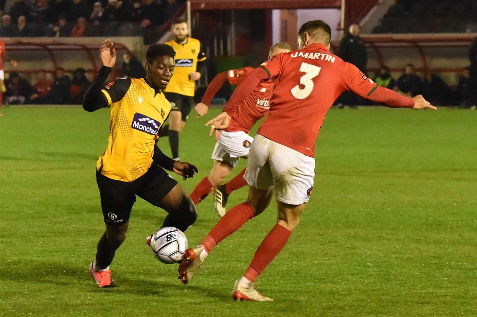 Maidstone winger Jermaine McGlashan runs at Ebbsfleet defender Joe Martin Picture: Steve Terrell