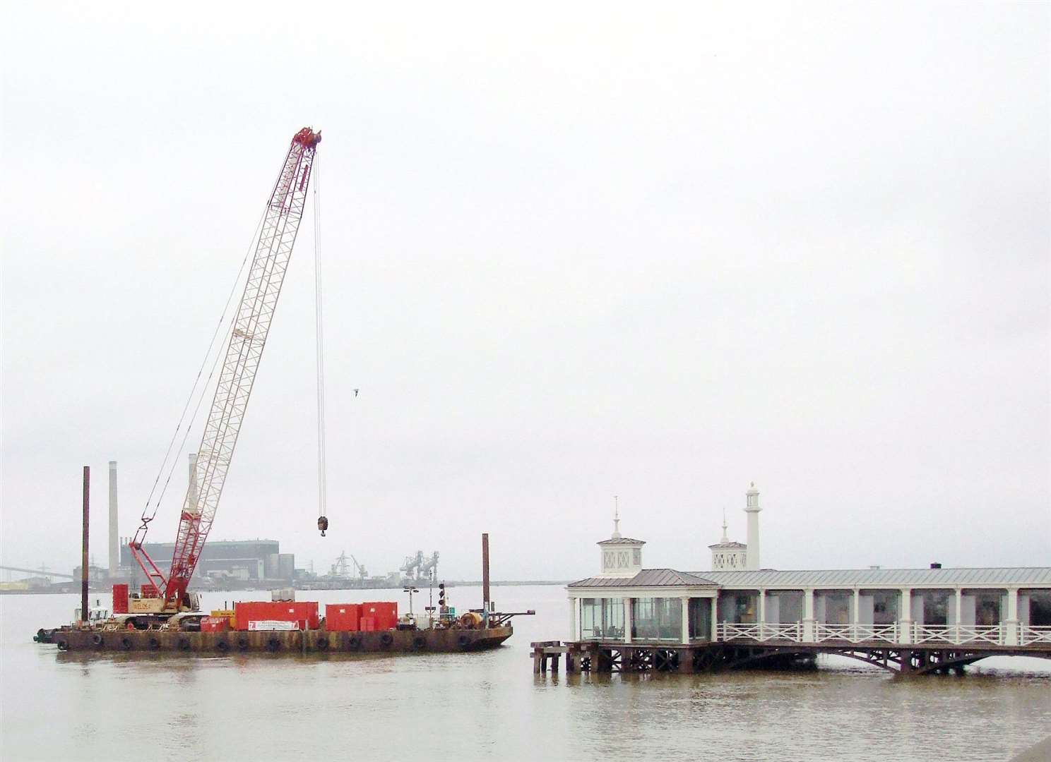 A crane lifts the footbridge over to provide the link between Town Pier and the new mooring pontoon. Picture: Alan Watkins