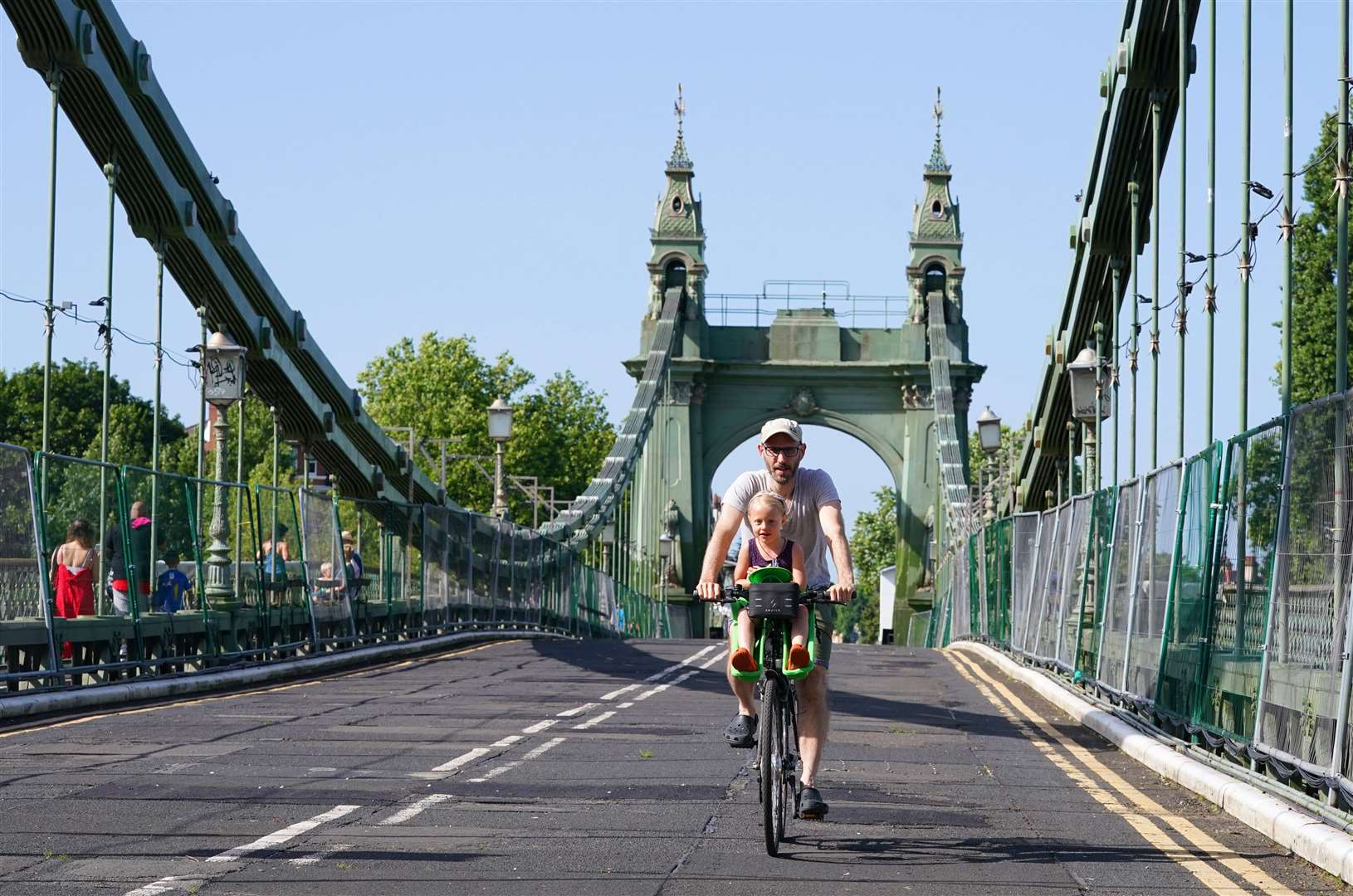 It was perfect weather as Hammersmith Bridge in London reopened to pedestrians and cyclists for the first time after a long closure on safety grounds (Jonathan Brady/PA)