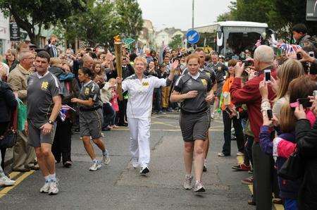 A torchbearer runs through Folkestone. Picture: Wayne McCabe