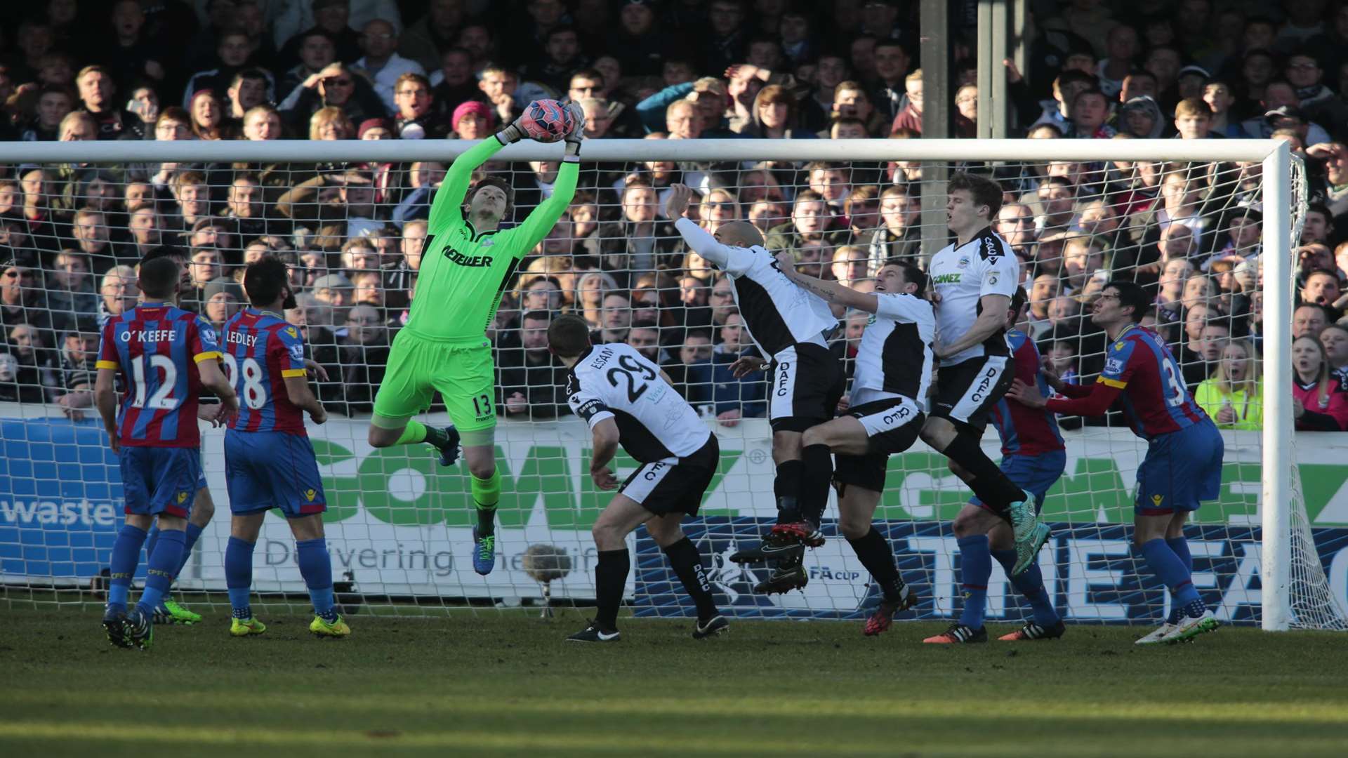 Crystal Palace keeper Wayne Hennessey beats the Dover players to the ball. Picture: Martin Apps.