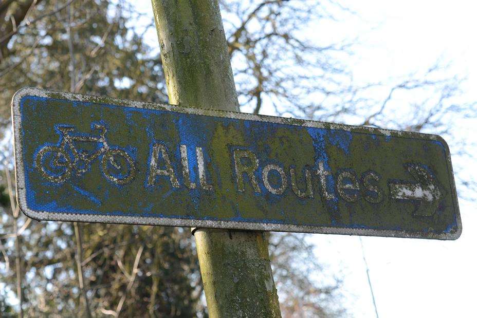 Moss covered signs near the Conningbrook roundabout in Kennington