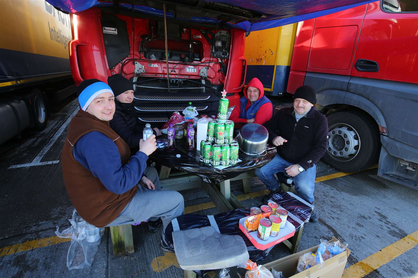 Lorry drivers share Christmas Day food and drinks at a truck stop near Folkestone, Kent (Gareth Fuller/PA)