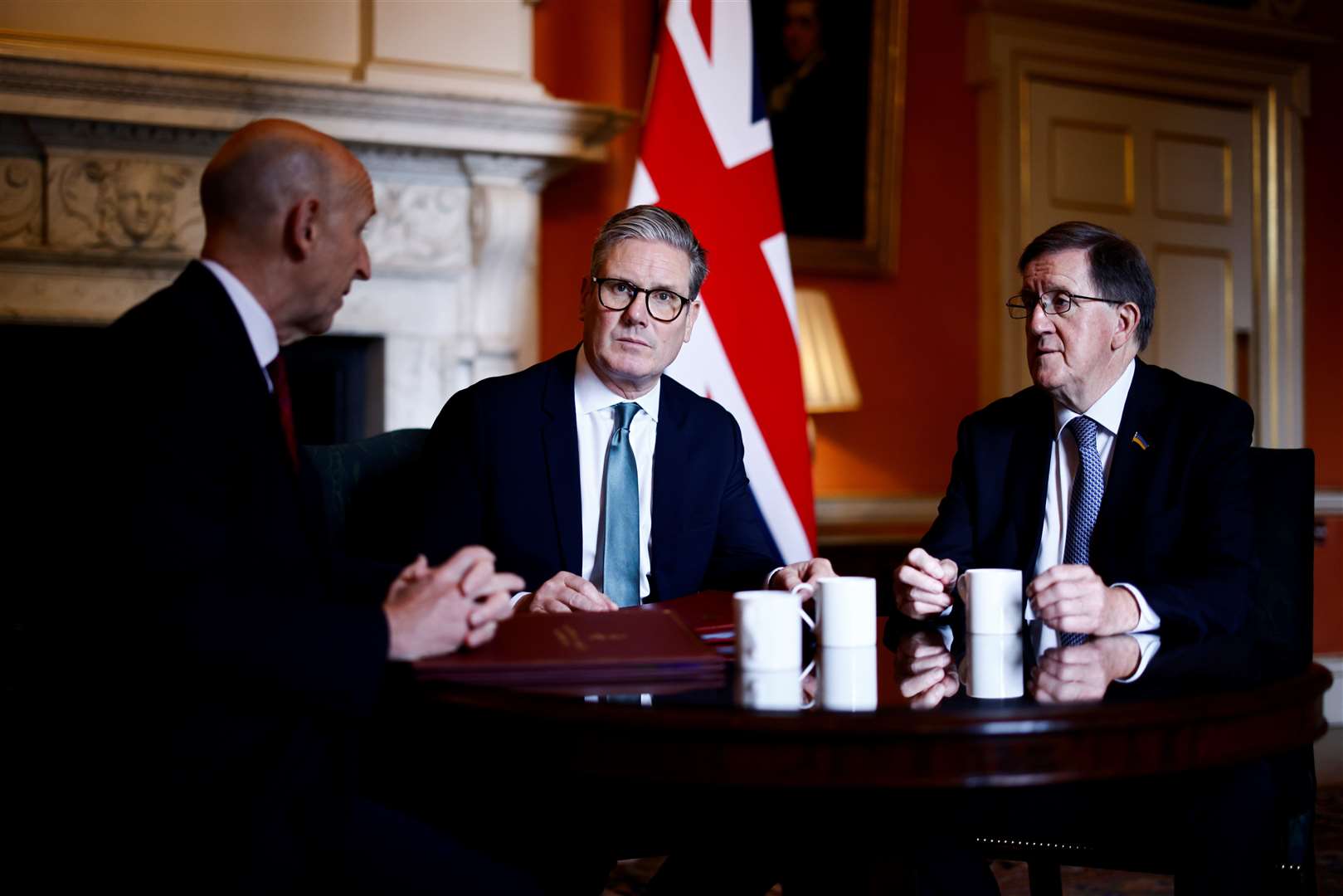 Sir Keir Starmer with Defence Secretary John Healey and former Nato chief Lord Robertson (Benjamin Cremel/PA)