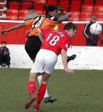 Gravesend's Lee Shearer heads clear during Saturday's game. Picture: STEVE CRISPE