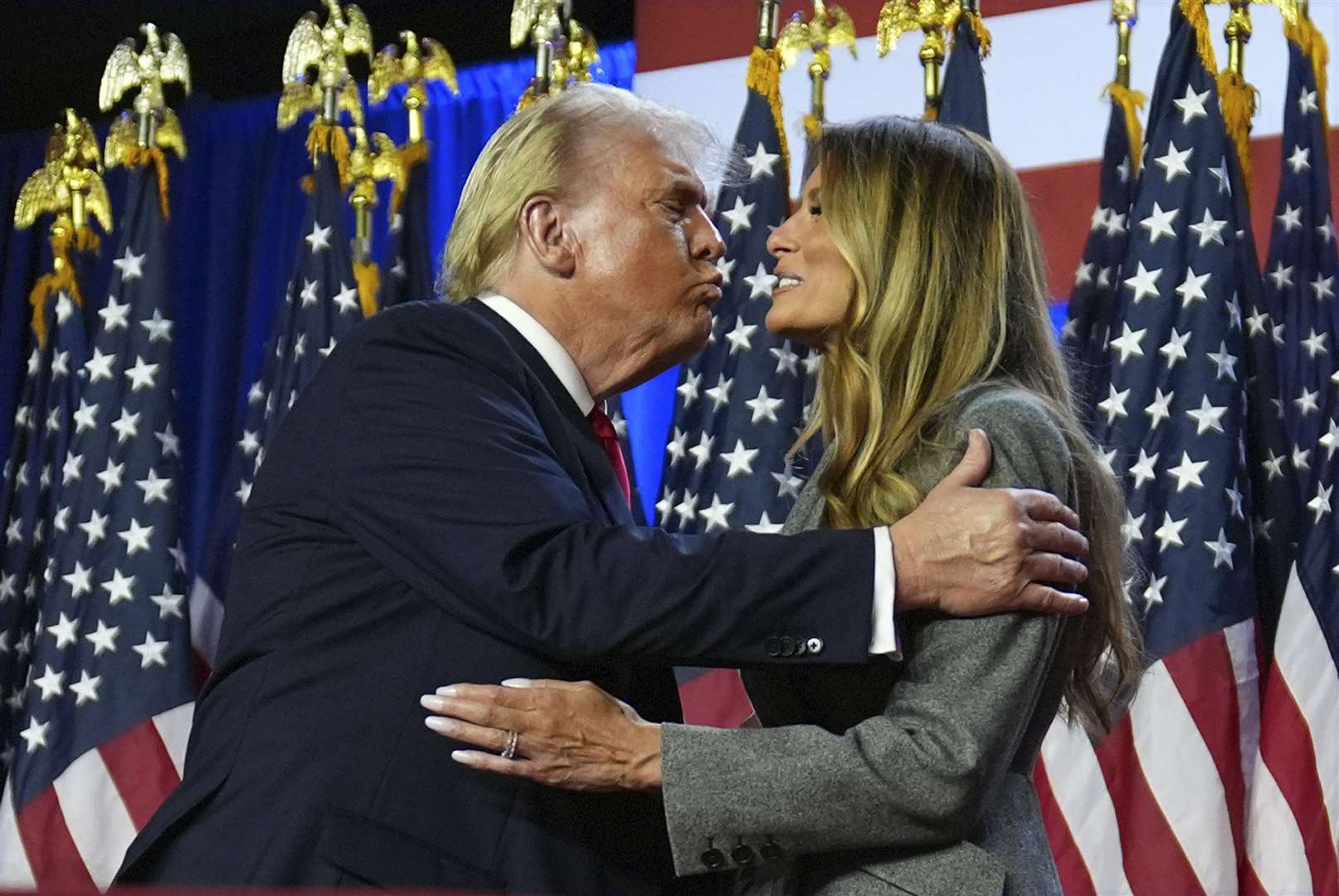 Donald Trump kisses former first lady Melania Trump at an election night watch party at the Palm Beach Convention Centre in Florida (Evan Vucci/AP)