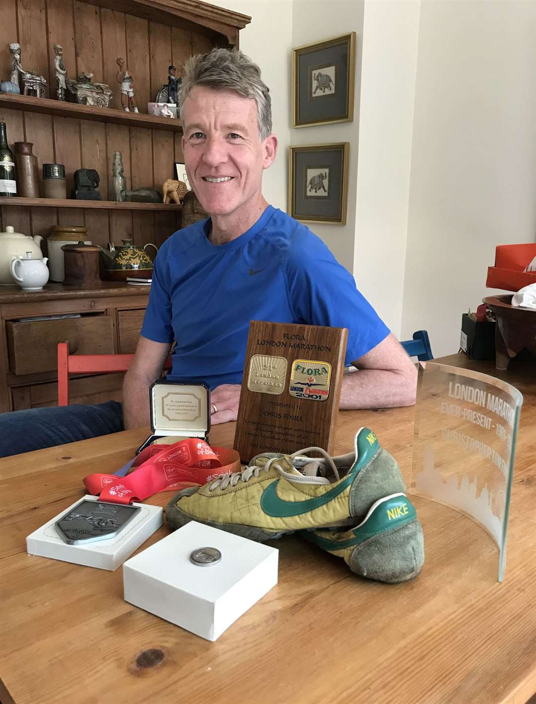 Chris Finill, one of the Ever Presents who have completed all 39 London Marathons, shows off memorabilia including his medal from the first event (Beverley Rouse/PA)