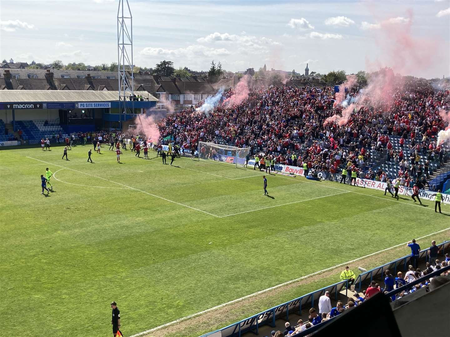 Rotherham United celebrate their second goal at Priestfield with flares set off in the stand and fans on the pitch