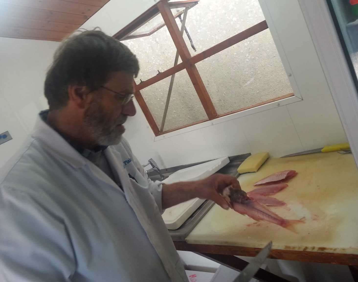 Fishmonger Herman Broekhuizen filleting a fish