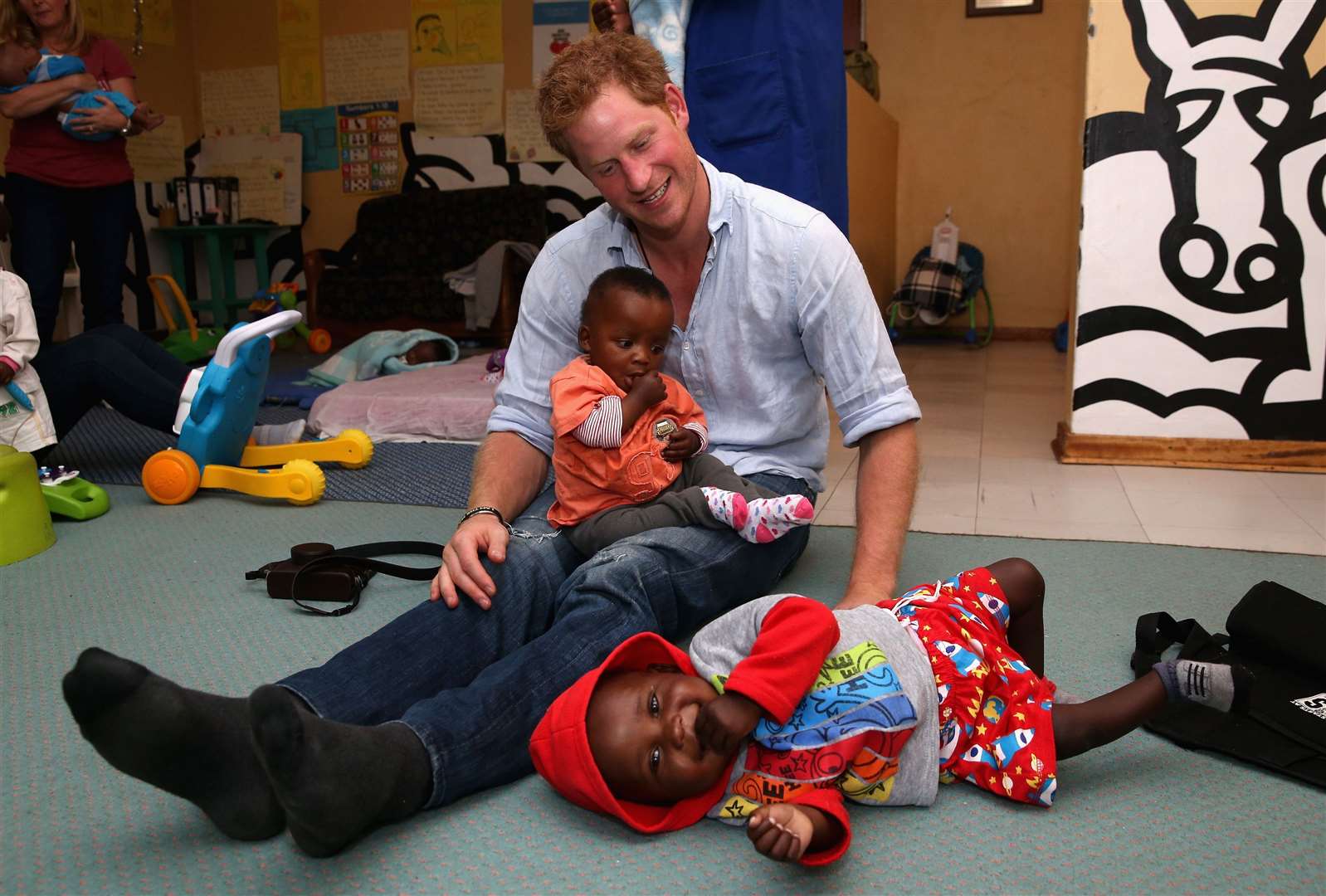 Harry visiting an organisation supported by Sentebale in 2014 (Chris Jackson/PA)