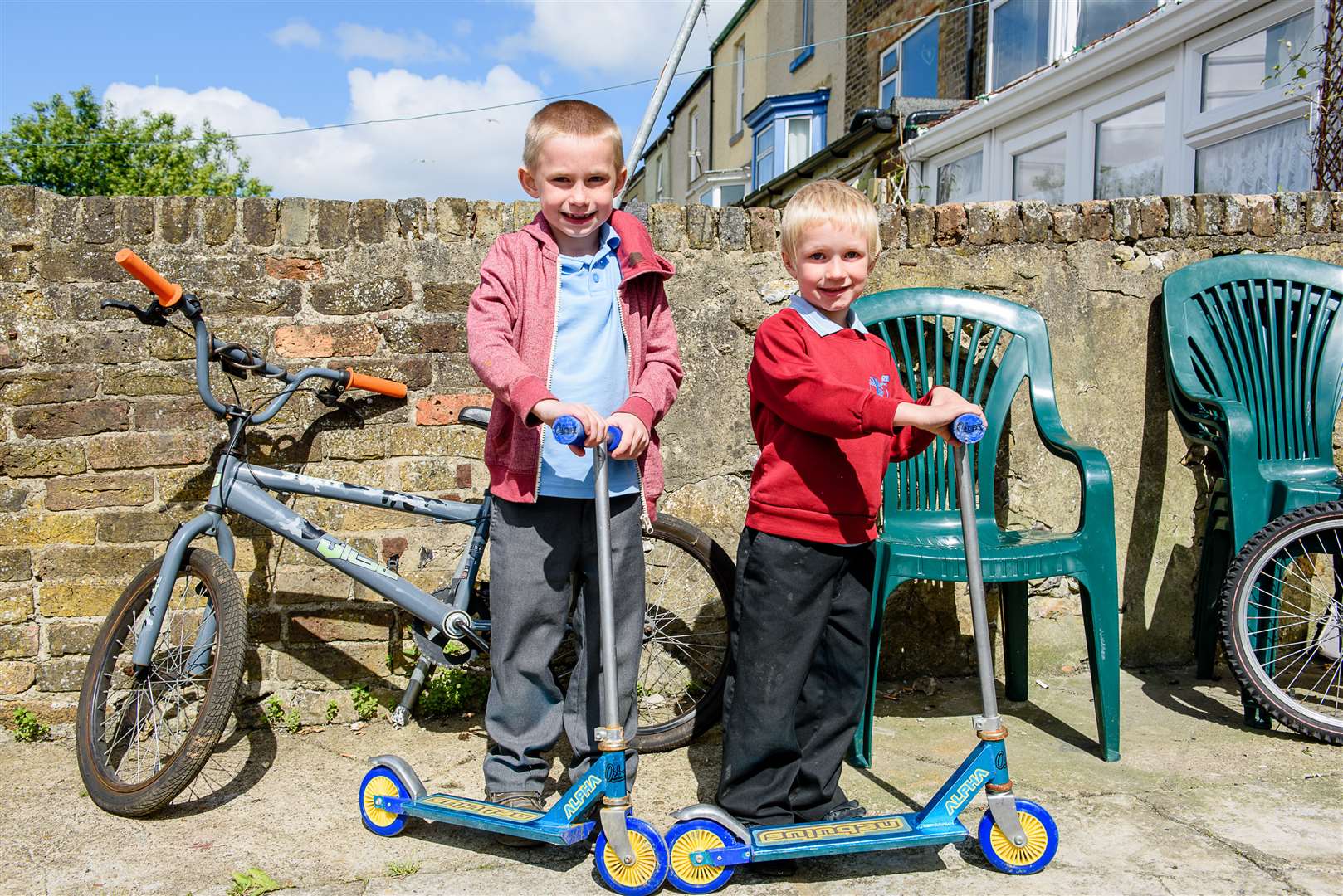 Peter and Ole with their new scooters, thanks to the generosity of the Dover community