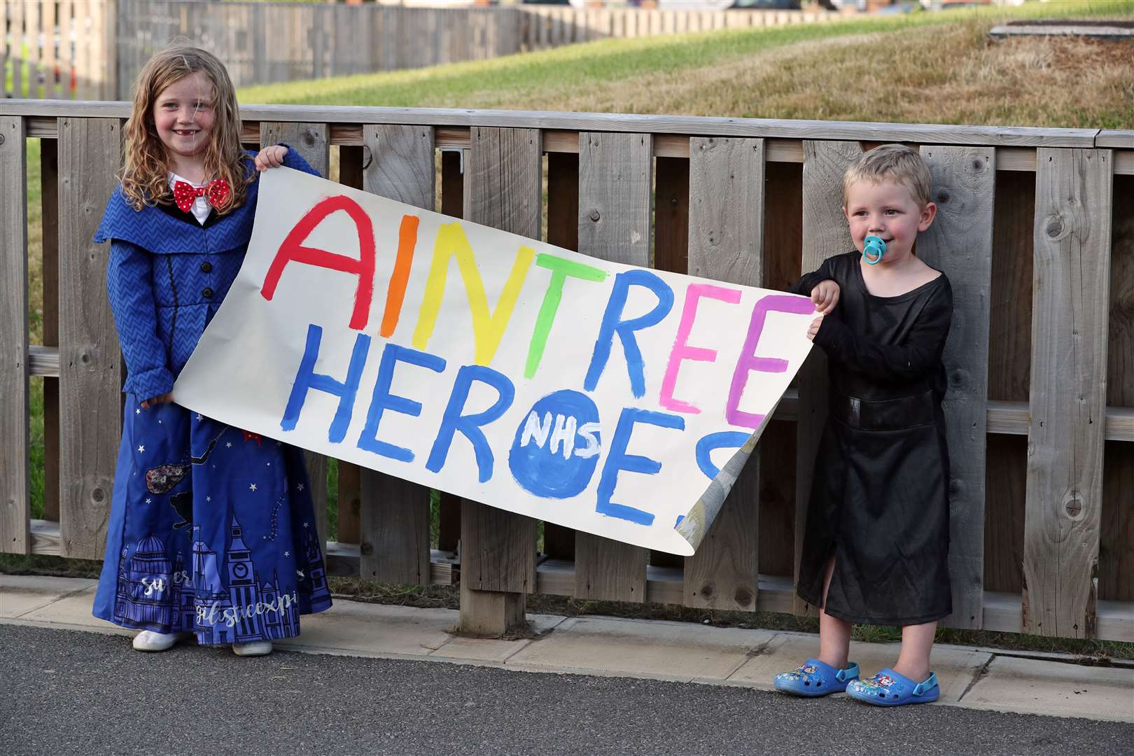 Children hold a banner outside Aintree University Hospital in Liverpool (Peter Byrne/PA)