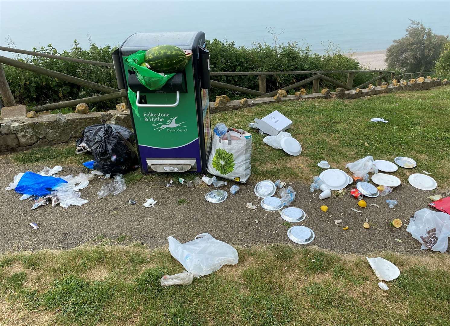 A watermelon was wedged into a bin in Folkestone, with other rubbish strewn nearby. Picture: Stephen West