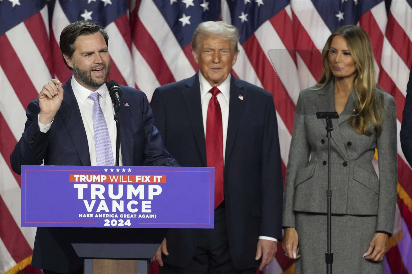 Republican vice presidential candidate JD Vance speaks as Donald Trump and former first lady Melania Trump watch at the Palm Beach County Convention Centre (Lynne Sladky/AP)