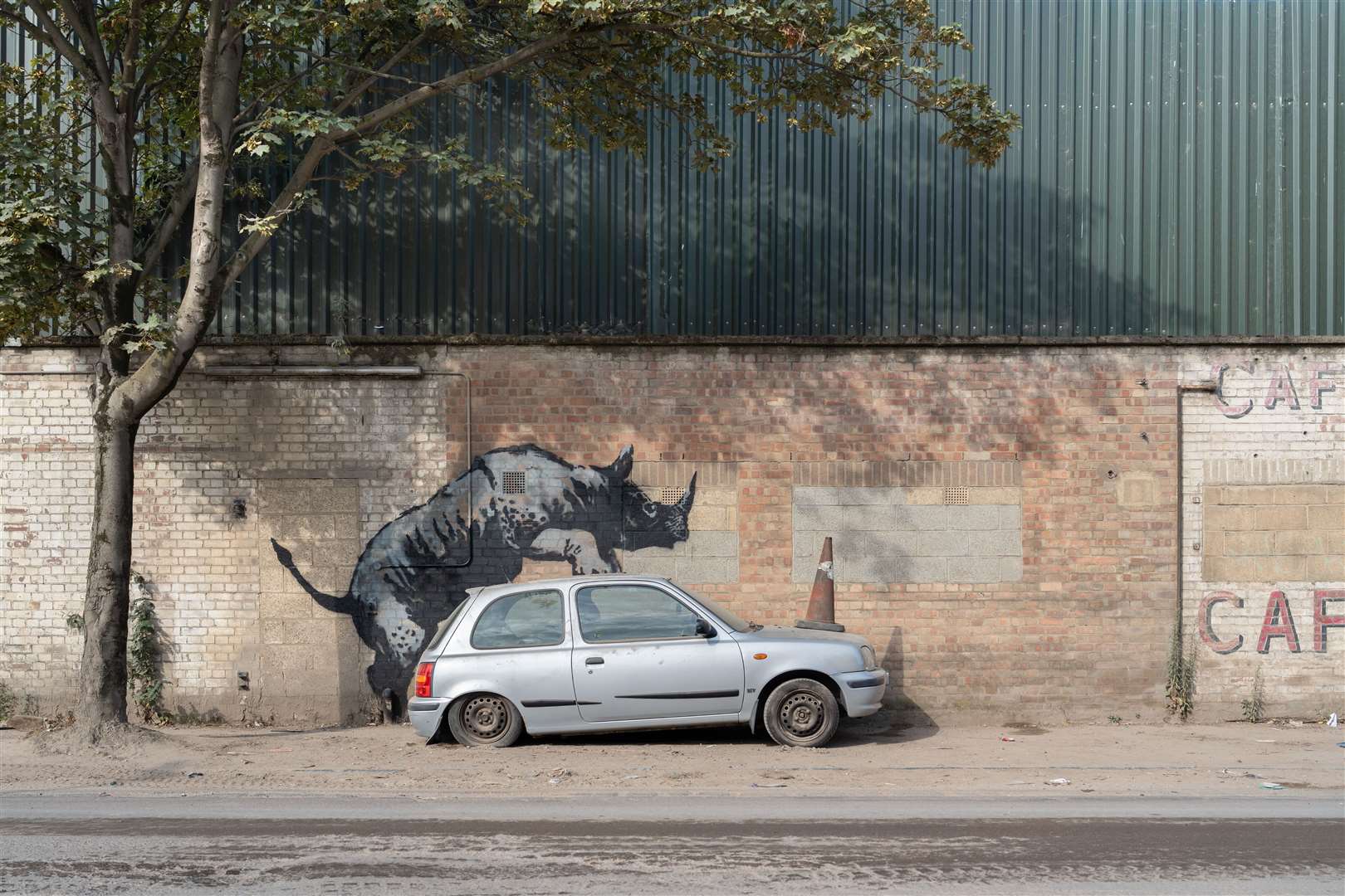 Banksy’s latest artwork depicts a rhinoceros climbing on top of a car (Banksy/PA)