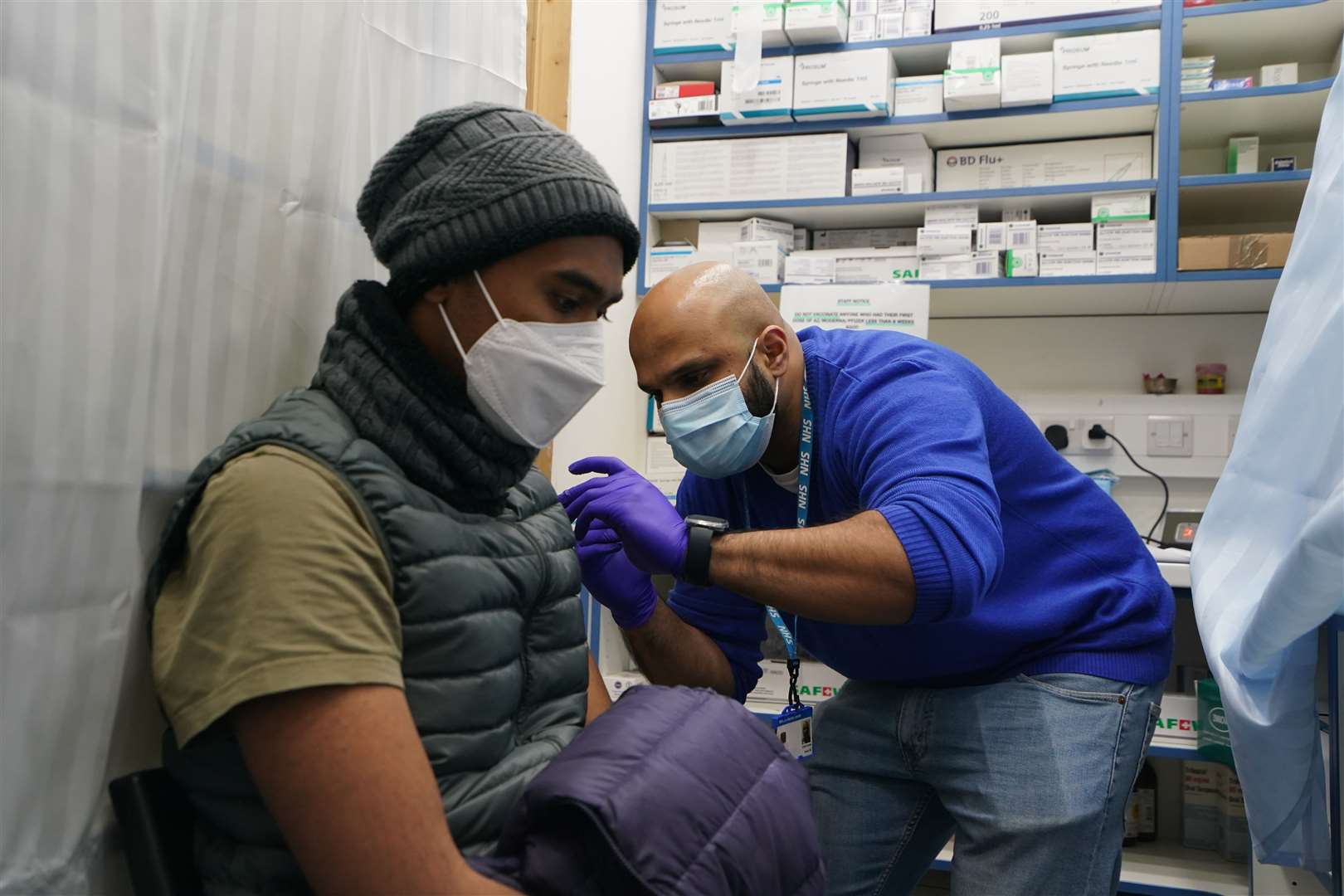 Nurse Salak Ali administers a booster jab (Gareth Fuller/PA)