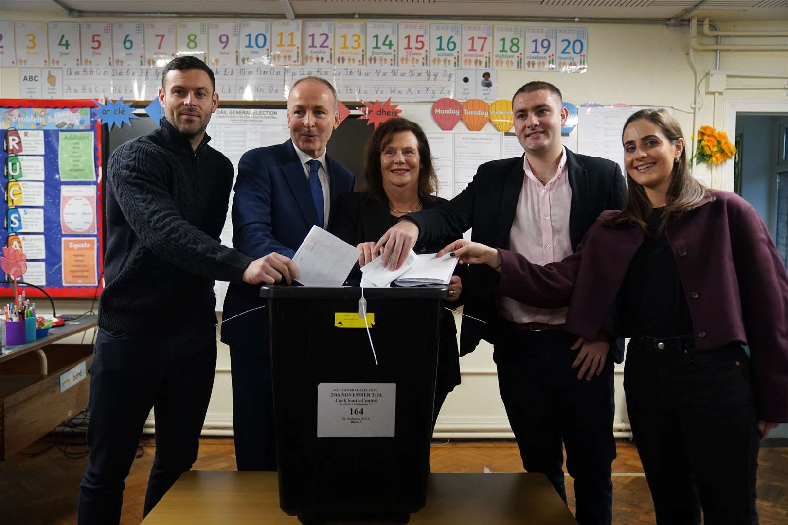 Tanaiste and Fianna Fail leader Micheal Martin, accompanied by his family, casts his vote at St Anthony’s Boys’ School, Beechwood Park, Cork (Jacob King/PA)