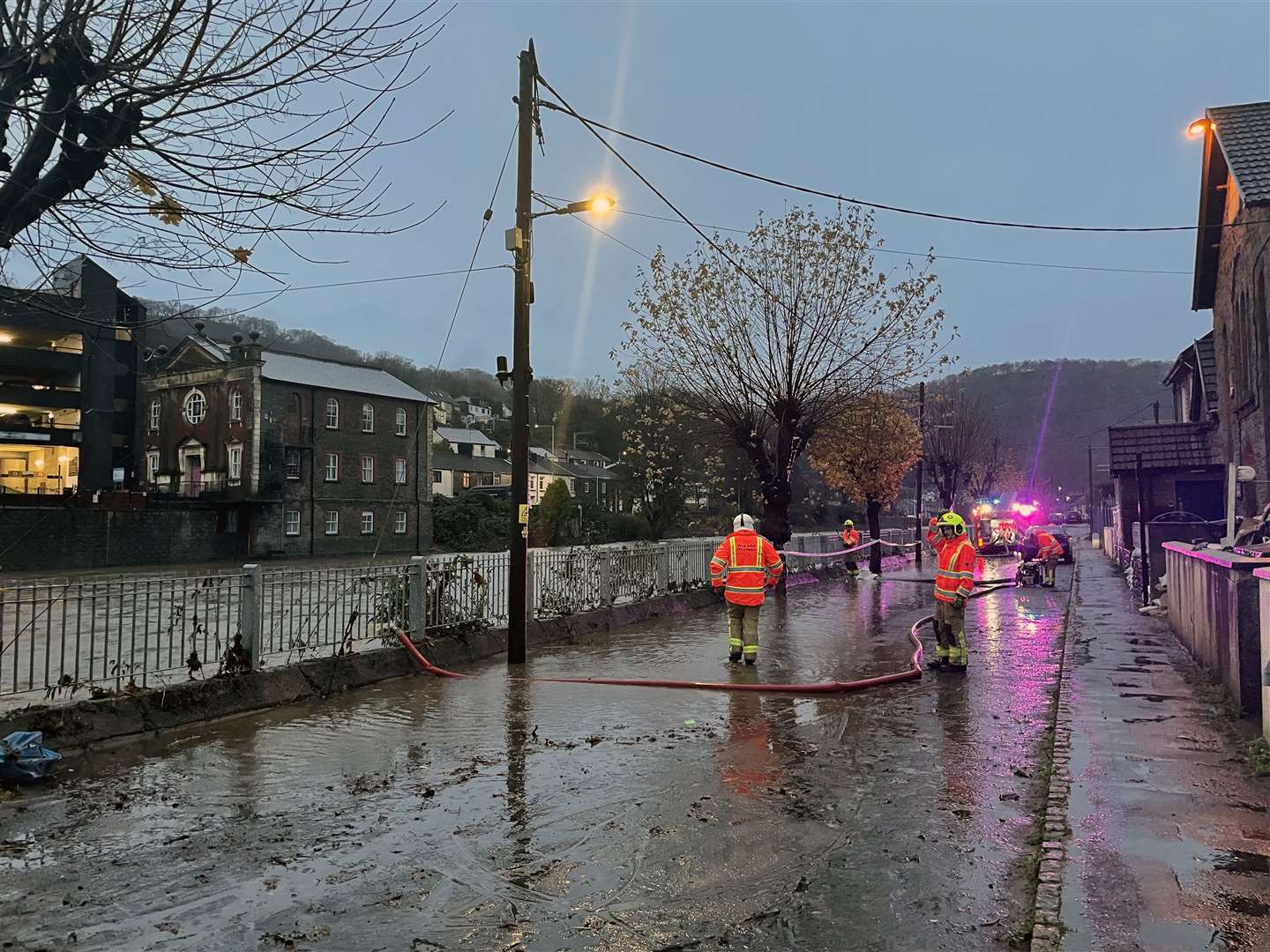 Firefighters pumping flood waters on Sion Street in Pontypridd, Wales (George Thompson/PA)