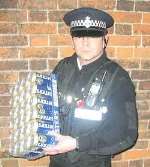 Faversham Town Centre Officer PC Gary Wood with a crate of Fosters beer he seized from a 17-year-old
